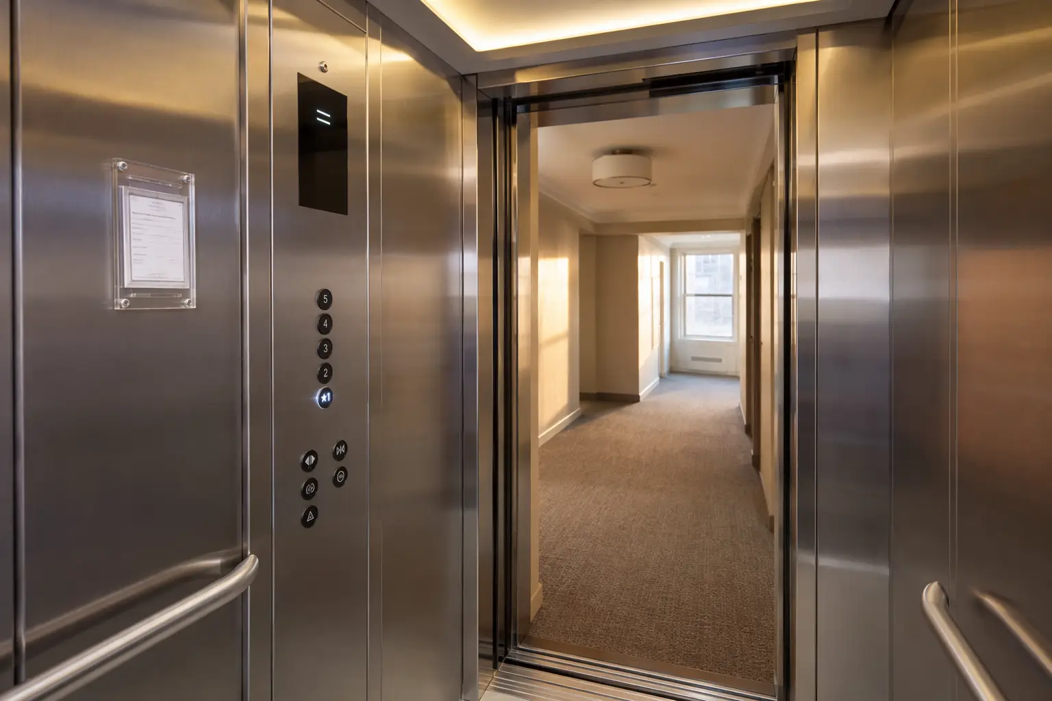 Modernized Elevator Cab Interior Affecting Maintenance Cost Modernized elevator cab interior with stainless steel walls and LED fixtures in a Philadelphia residential building, showing how elevator age and condition affect annual maintenance costs
