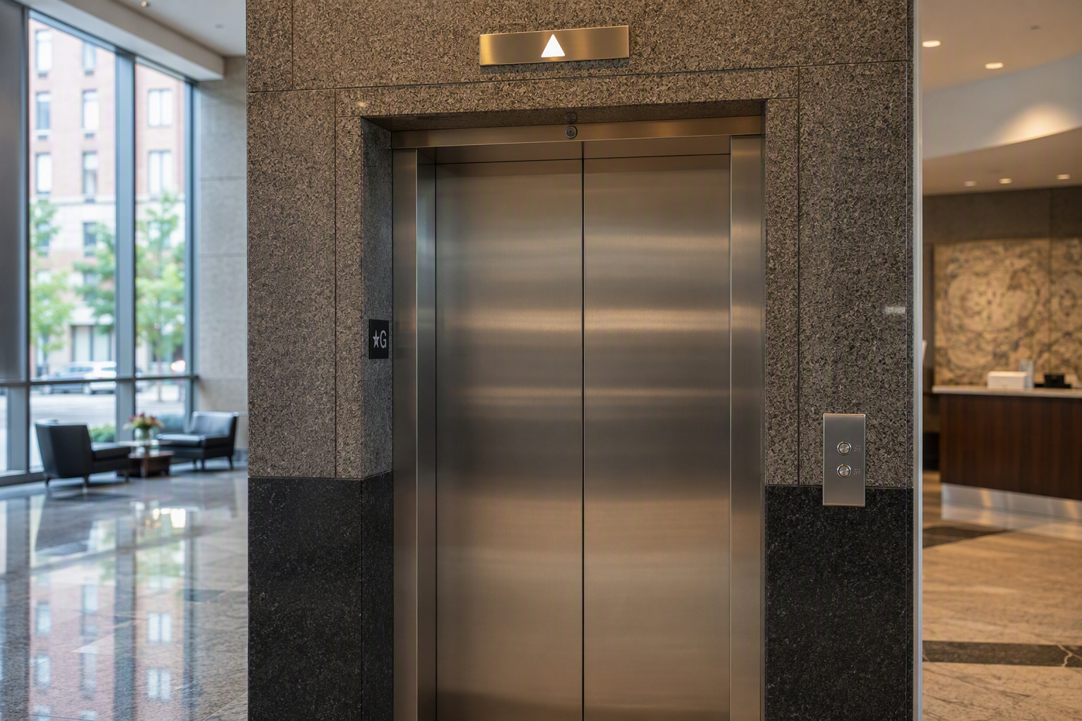 ADA-compliant elevator entrance with raised call buttons, arrival lantern, and Braille jamb signage in a Baltimore MD commercial office building lobby