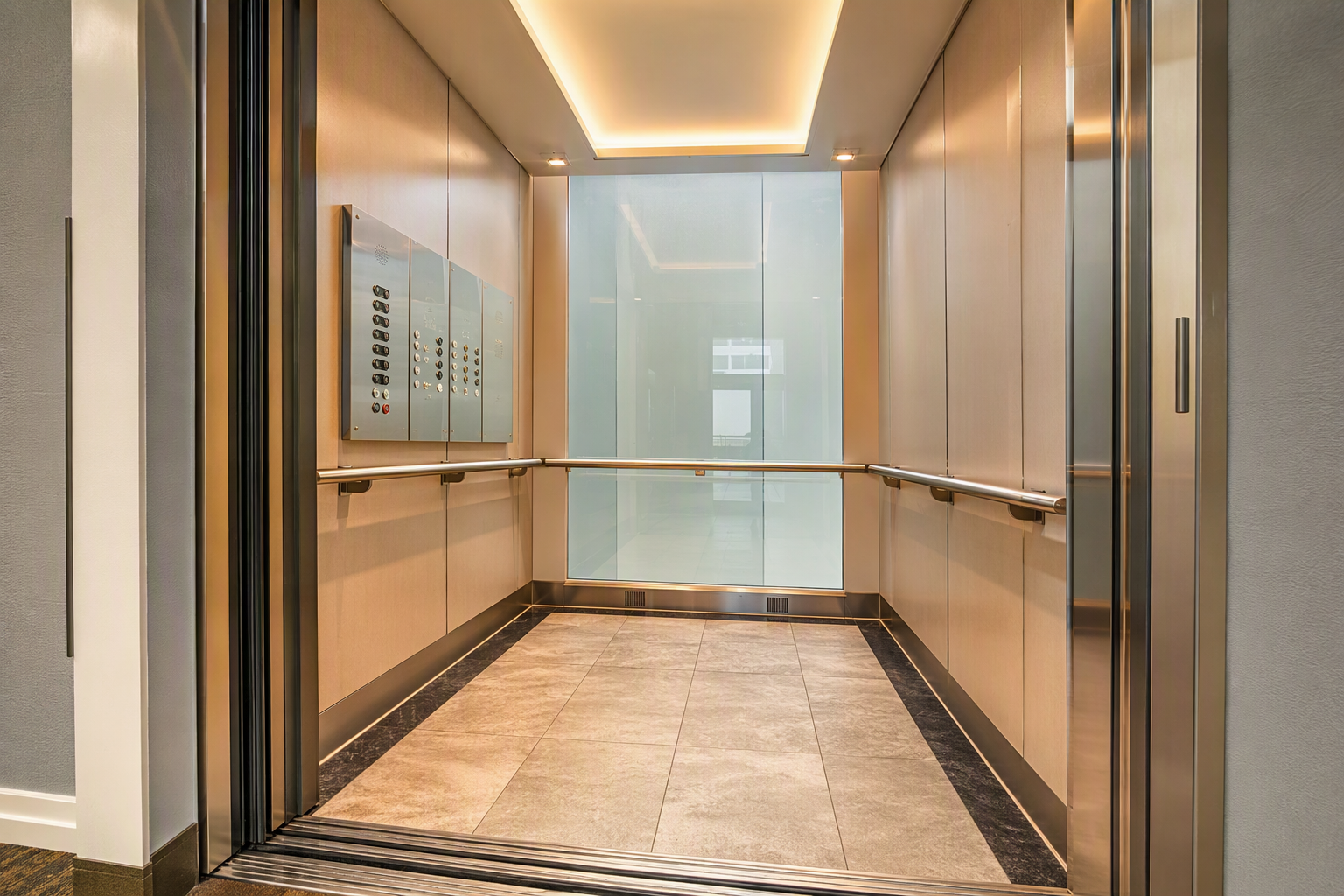 Interior of a modernized senior living elevator cab showing ADA-height control panel, Braille buttons, three-wall handrails, and slip-resistant flooring meeting senior living elevator requirements