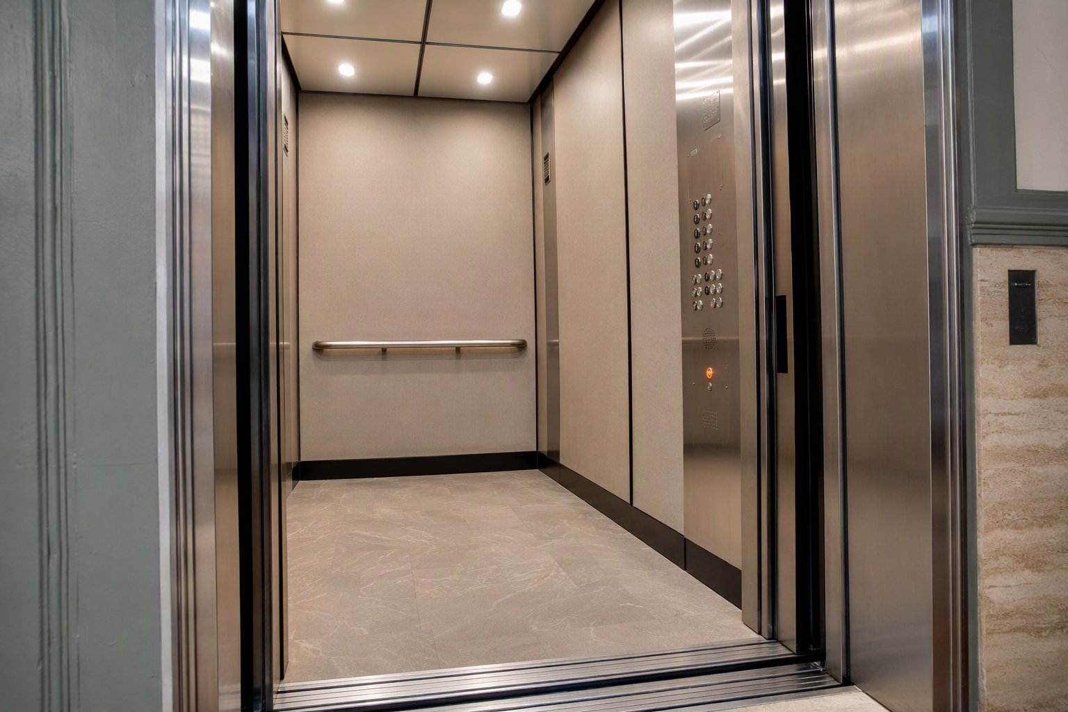 Modernized elevator cab interior showing ADA-compliant Braille controls, LED ceiling lighting, and stainless fixtures in a Philadelphia residential building